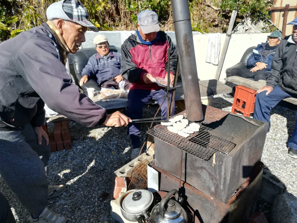 Aged men cook Mochi.